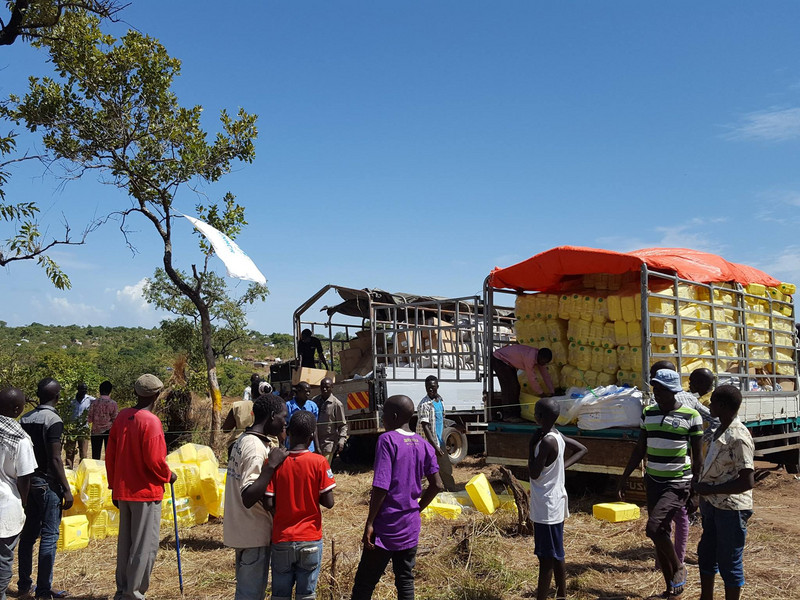 Distribution of water containers to new refugee arrivals in Uganda