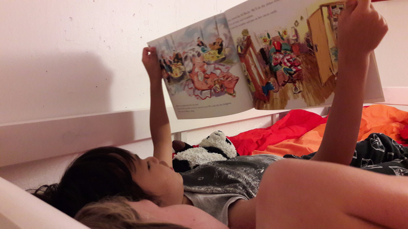 Emmas friend reading her a bed time story on their sleep over