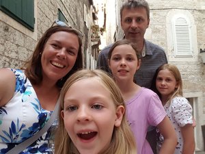 Family selfie in the small streets, on the search for ice cream