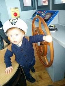 Flynn steering the boat in the Glasgow Science Centre