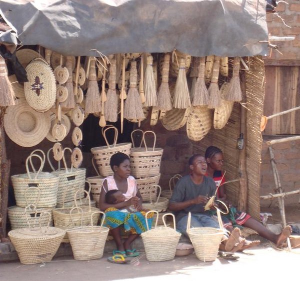 Women weaving baskets at a roadside market in Zambia