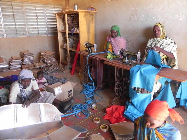 Women making solar cookers