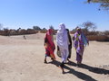 Women walking through the camp