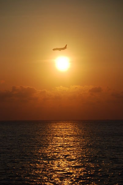 jet landing in the sunset