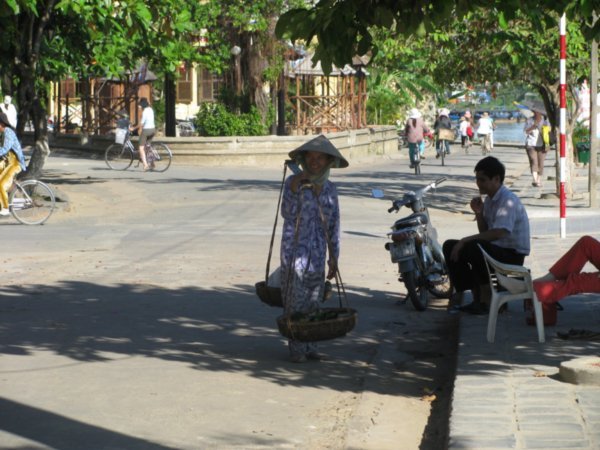 Typical Vietnamese lady carrying stuff