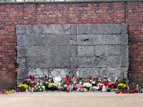 Floral tributes at the death wall, Auschwitz