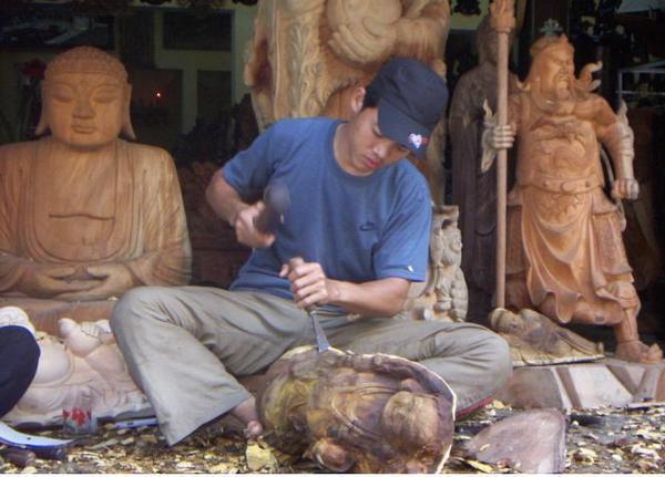 A local wood-carver in Hoi An