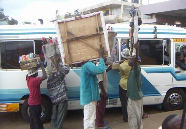 More wooden-plank men crowding a bus