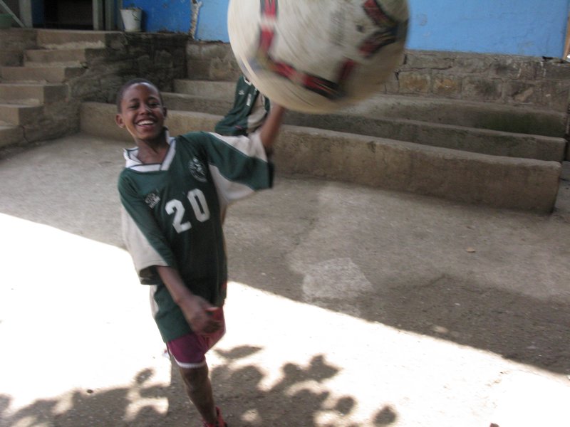 Abebe kicking the soccer ball