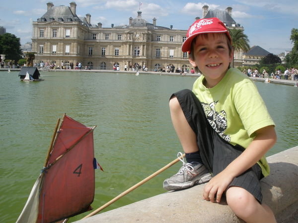 Aussie kid sailing his boat on the pond