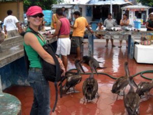 Monia buying fresh fish for Kiki... not, she is posing with Pelicans