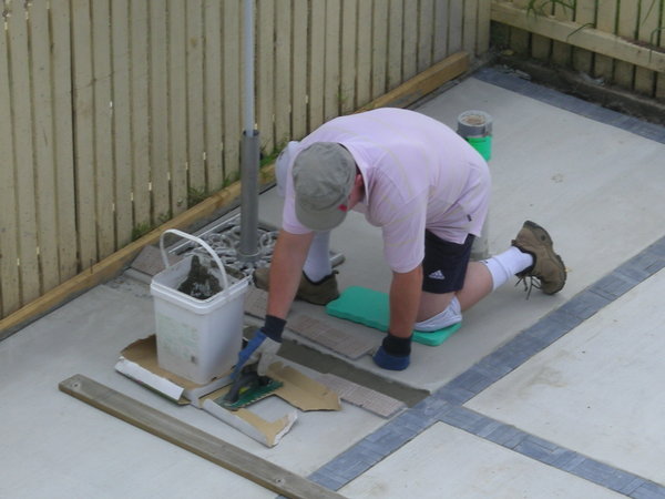 Kevin grouting the tiles.