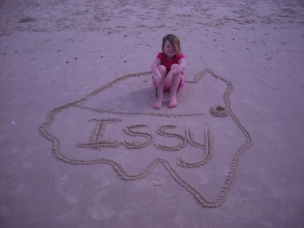 Drawing pictures in the sand.