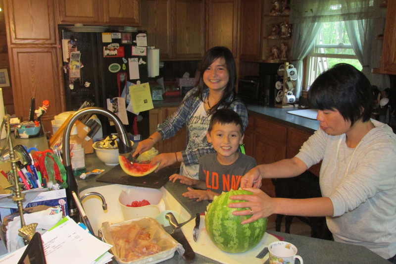 Hiroko and kids making fruit bowl