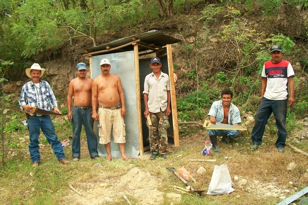 the guys building a community latrine