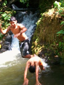carlos and ozmancito swimming in the river