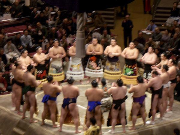 Sumo wrestlers enter the ring before competing