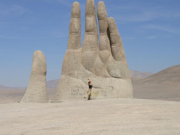 High fiving the giant hand in the desert