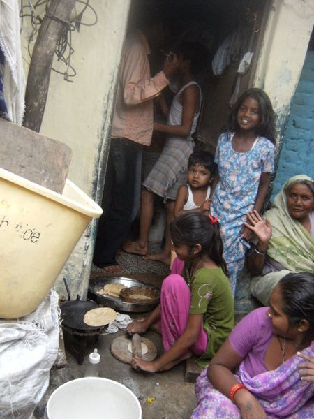 In the slum colony - girl making chapatis