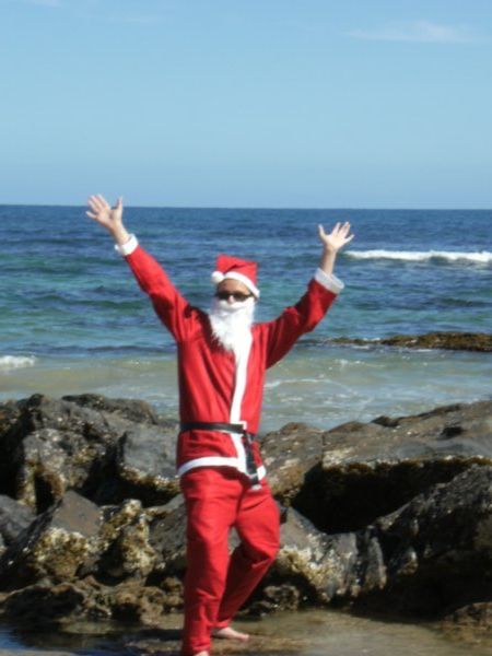 Santa, having completed the night before Chrissy rounds, arrives for some sunbeams at Appollo Bay beach