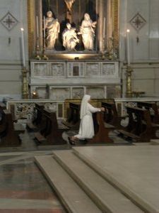 Nun praying inside cathedral