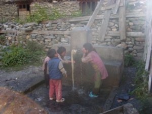 children washing at communal tap