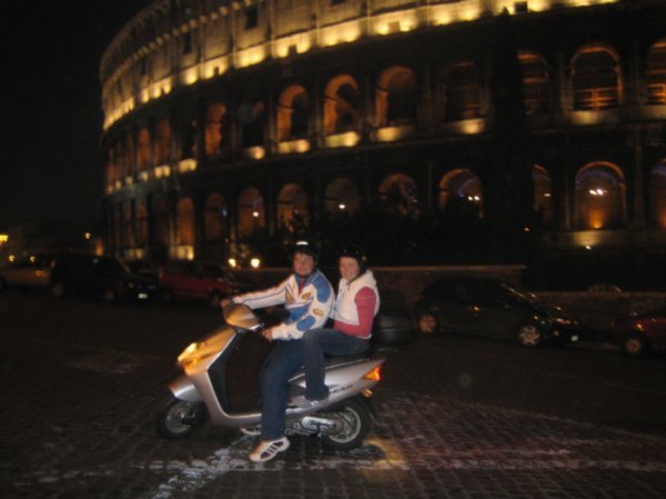 zach and i on the moped with the colloseum in the background