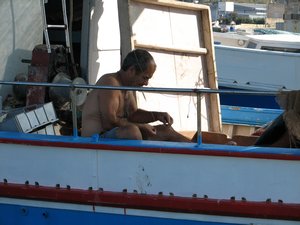 Fisherman At Work in Marsaxlokk Bay