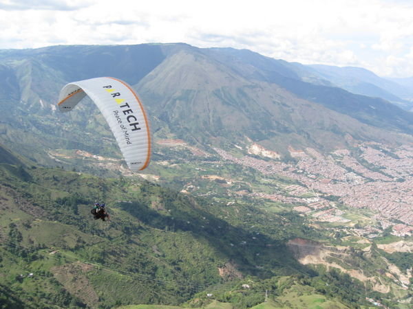 Chasing down a fellow paraglider.
