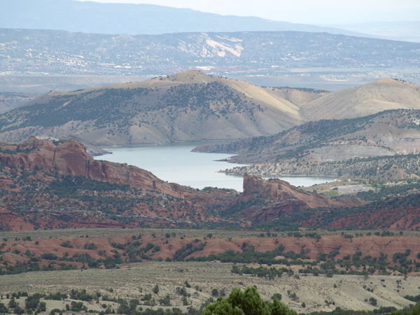 View of reservoir surrounded by red cliffs.