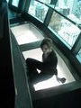 Abi sits on the glass hundreds of feet up.