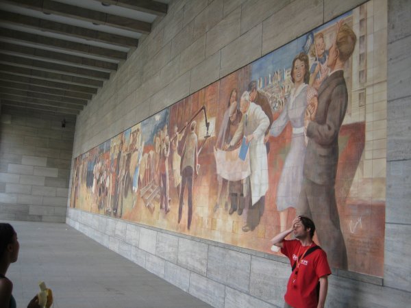 Our free tour guide and a communist mural