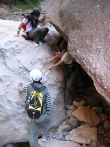 Ali and Emma scrambling through the canyon while Luis 'helps'