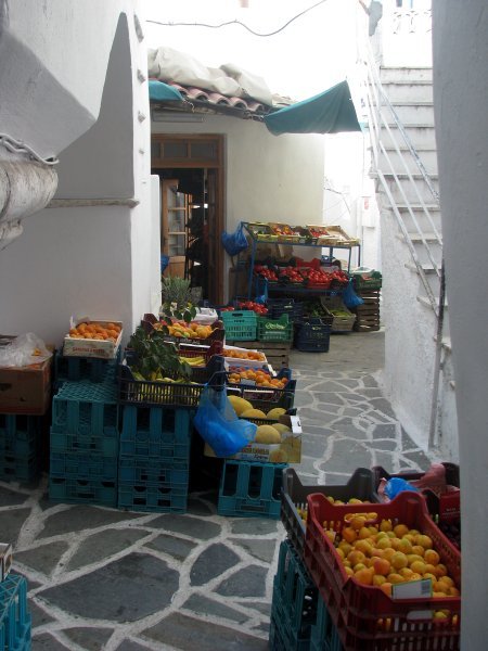 The green grocer's shop spread along the narrow paths