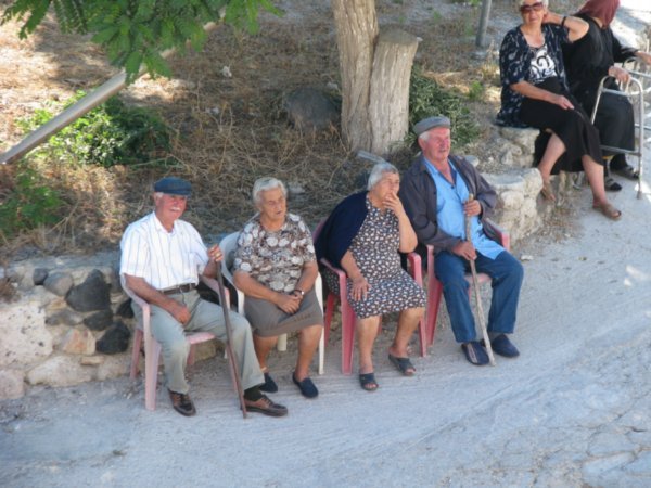 In the cool of the afternoon, old folk sit and chat