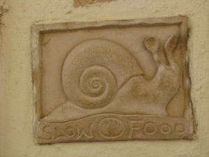 This plaque  is outside a fine Italian restaurant in Oia and opitimises the relevance of food in Santorini