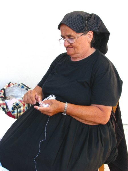 Hvar woman in black crocheting