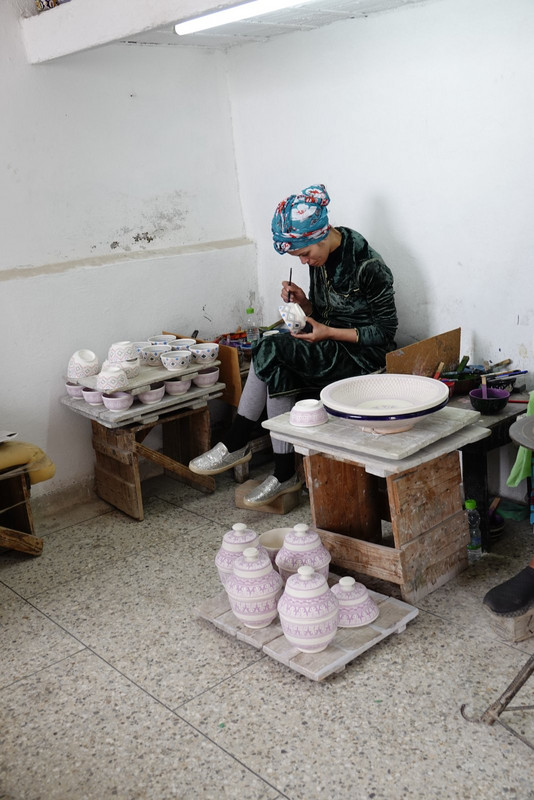 Hand painting the pottery