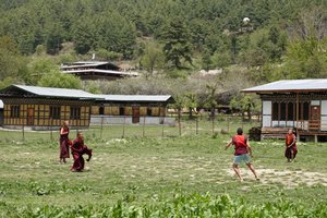 Young monks playing football (soccer)