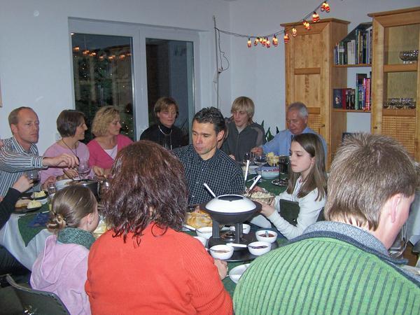 Family sitting around eating Fondue =)