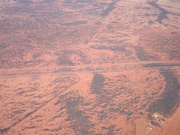 The Highway and Ghan train track run together towards Darwin