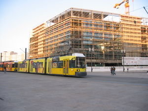 A tram and another new building