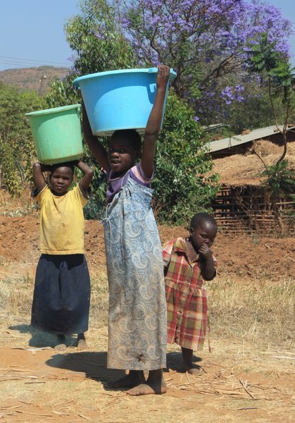Some kids carrying out their usual duties of collecting the water