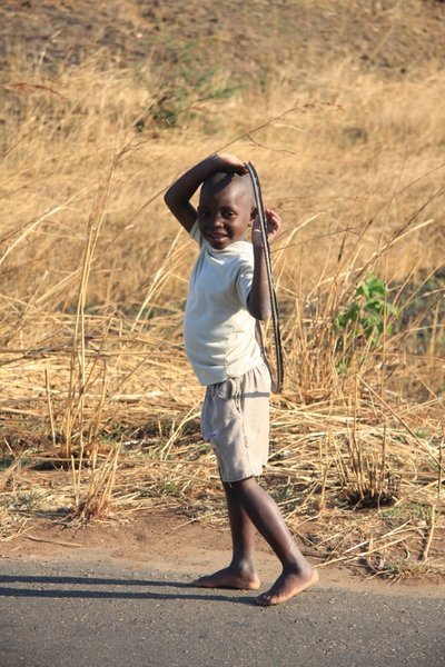 A young boy playing with a hoop