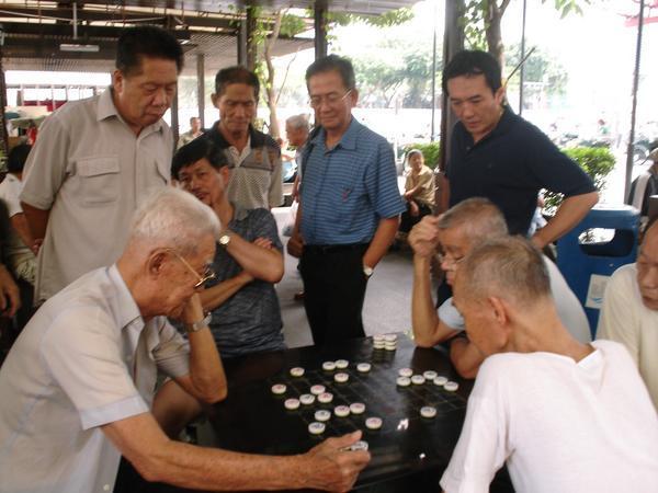 Men playing draughts in Chinatown