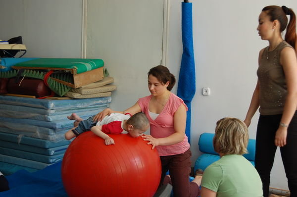Demonstrating use of therapy ball on Tuesday
