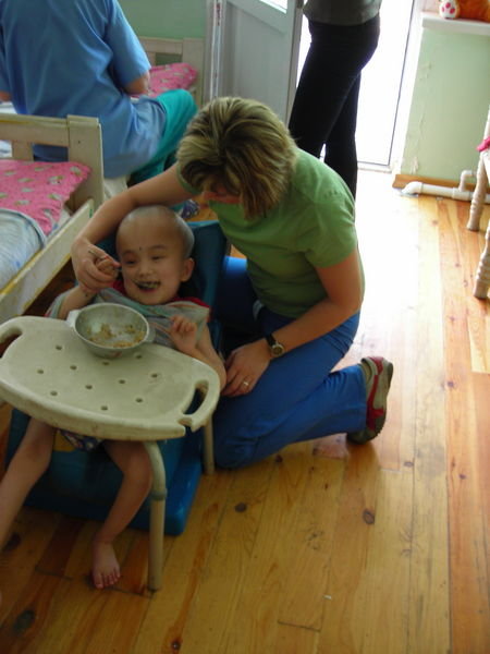 Ella feeding a child in a tumbleform