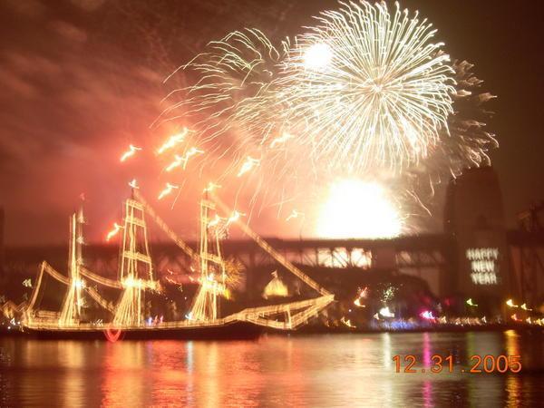 Fireworks behind one of the tall ships
