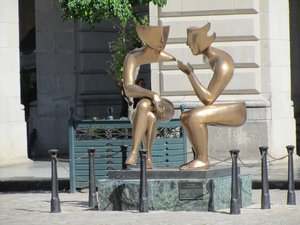 A modern statue titled, "Conversation".
