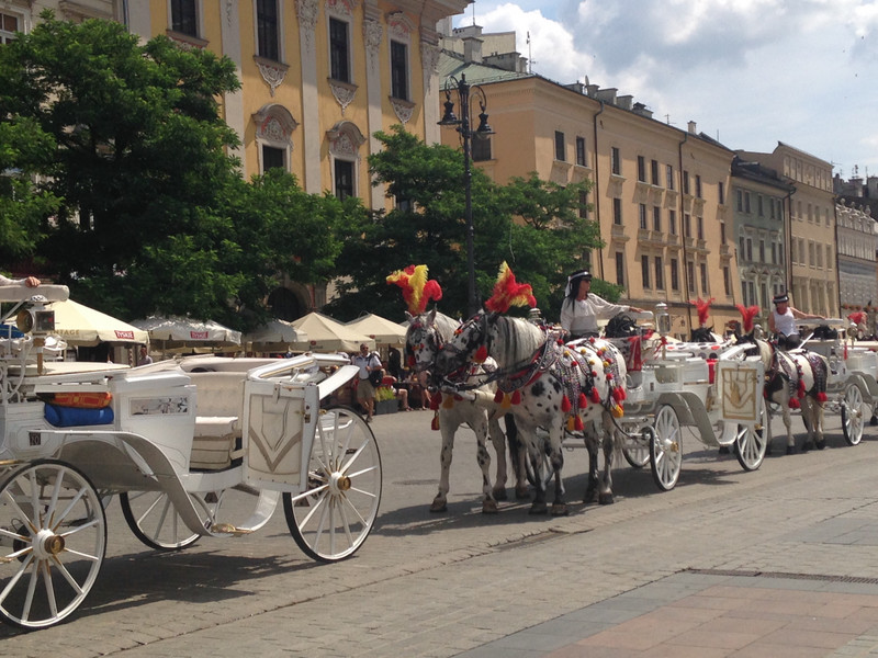 Horse carriages line the perimeter of the square